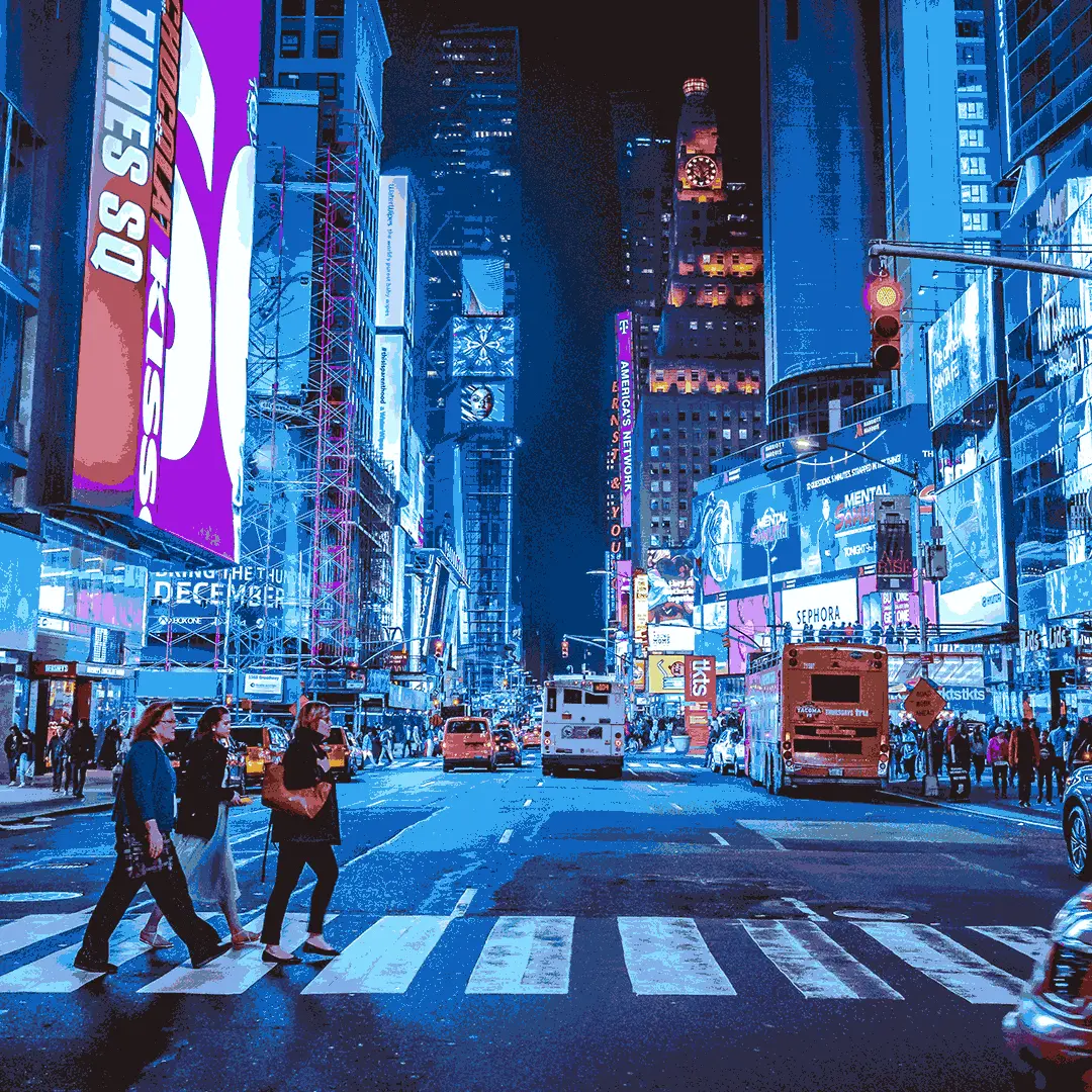 The lights of Time Square at night time from the road in New York